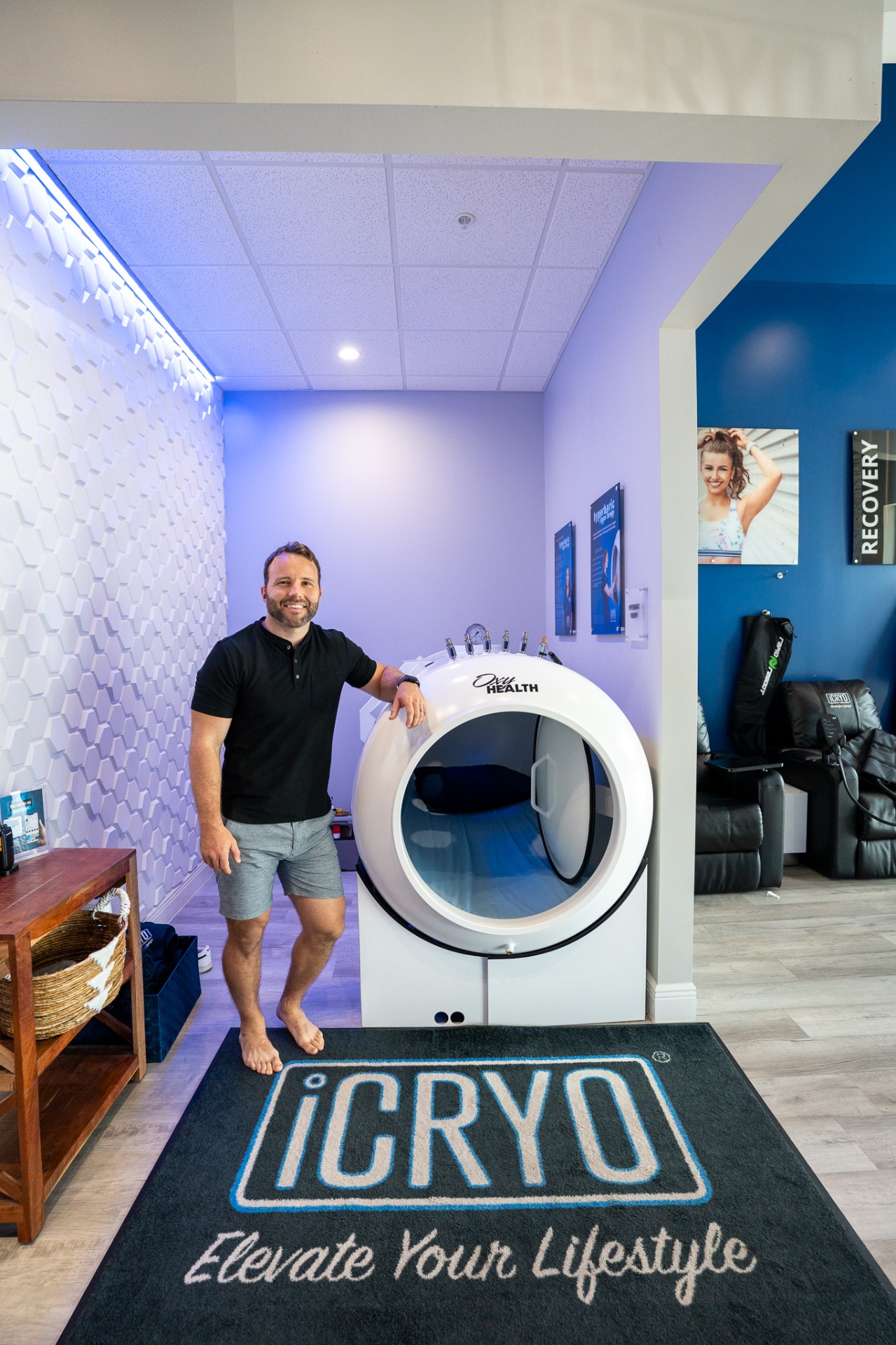 Owner next to the OxyHealth Fortius 420 hard-shell hyperbaric chamber at iCRYO SouthPark