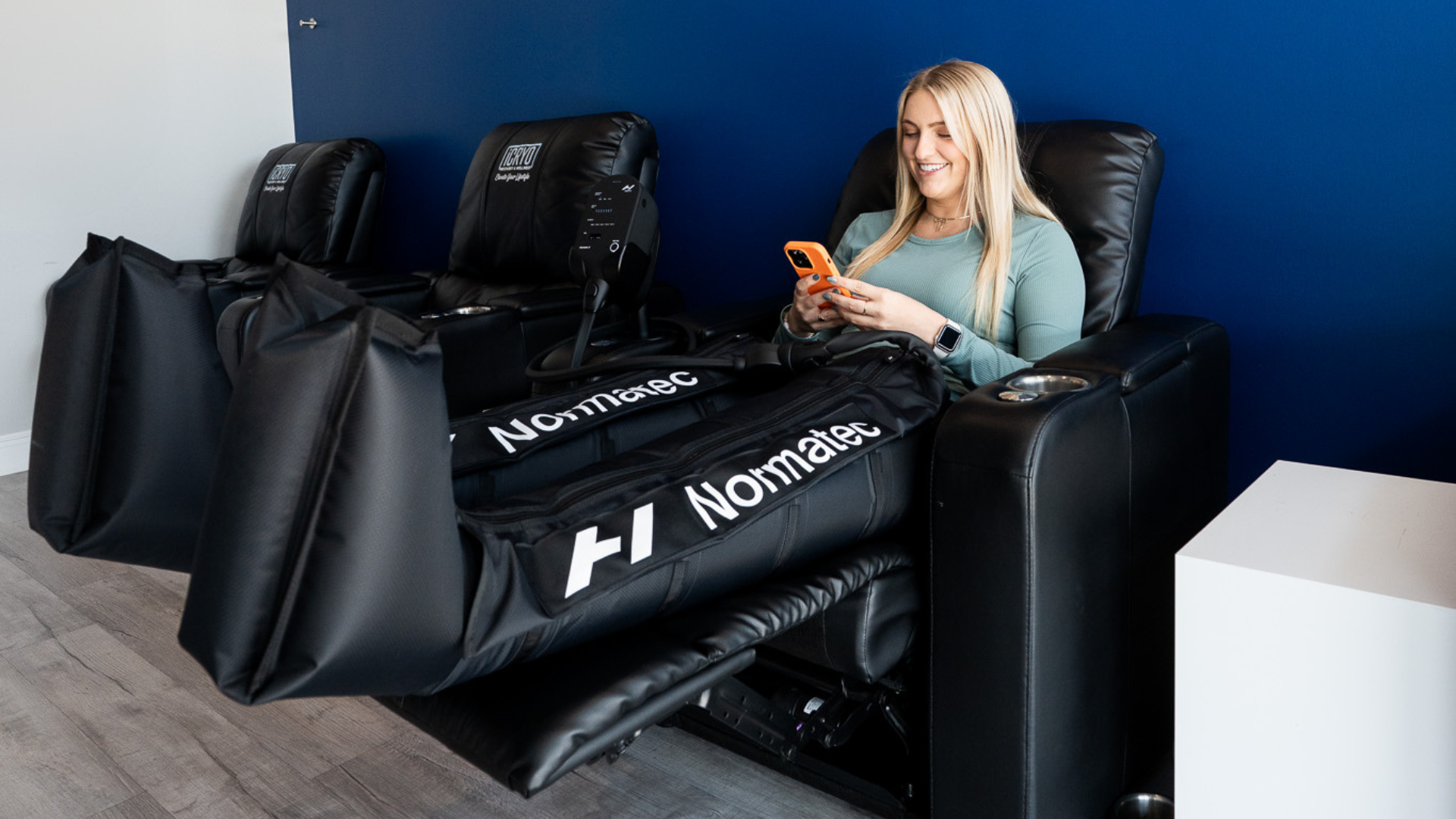 Client relaxing in compression boots at iCRYO SouthPark